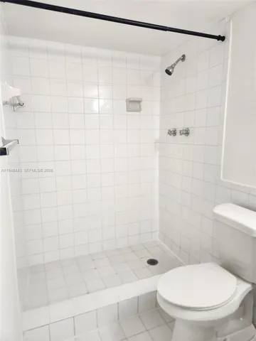 a bathroom with a shower and a toilet