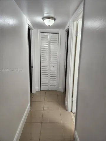 an empty room that has a kitchen in it