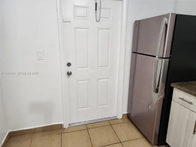a view of a refrigerator in kitchen counter top space