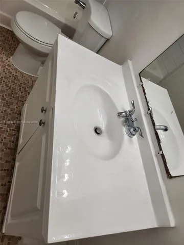 a bathroom with a sink and mirror