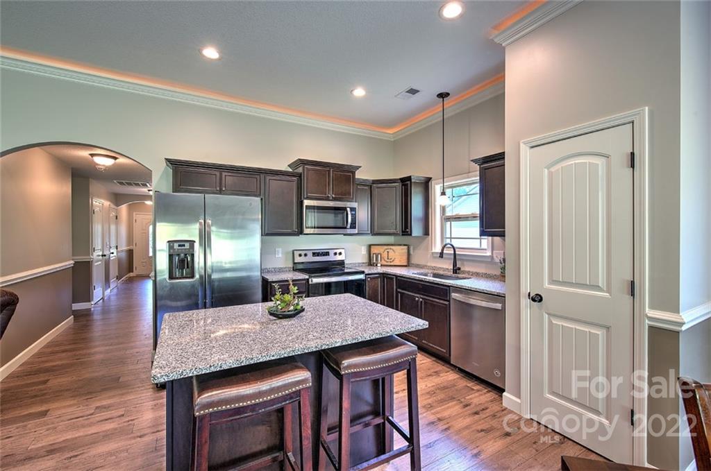233 Sunward Path Inman, SC 29349 - Photo 32 of 48 a kitchen with stainless steel appliances granite countertop a stove refrigerator and cabinets
