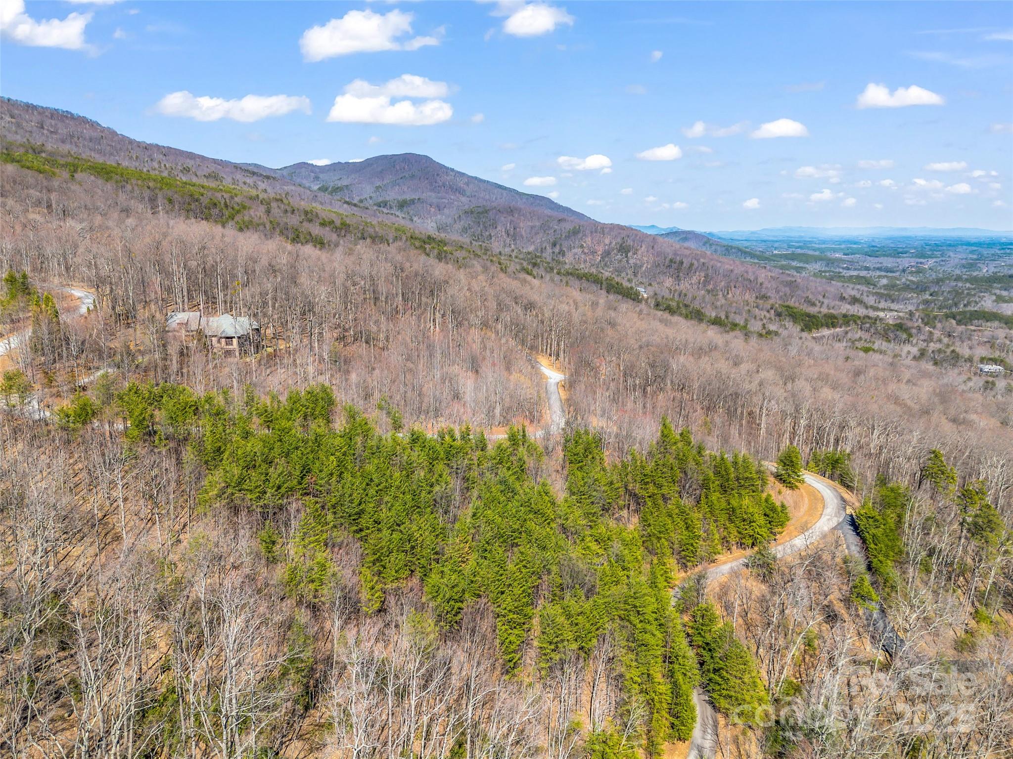 190 Cherry Hill, Unit NONE Mill Spring, NC 28756 - Photo 26 of 32 a view of a lake with a mountain in the background