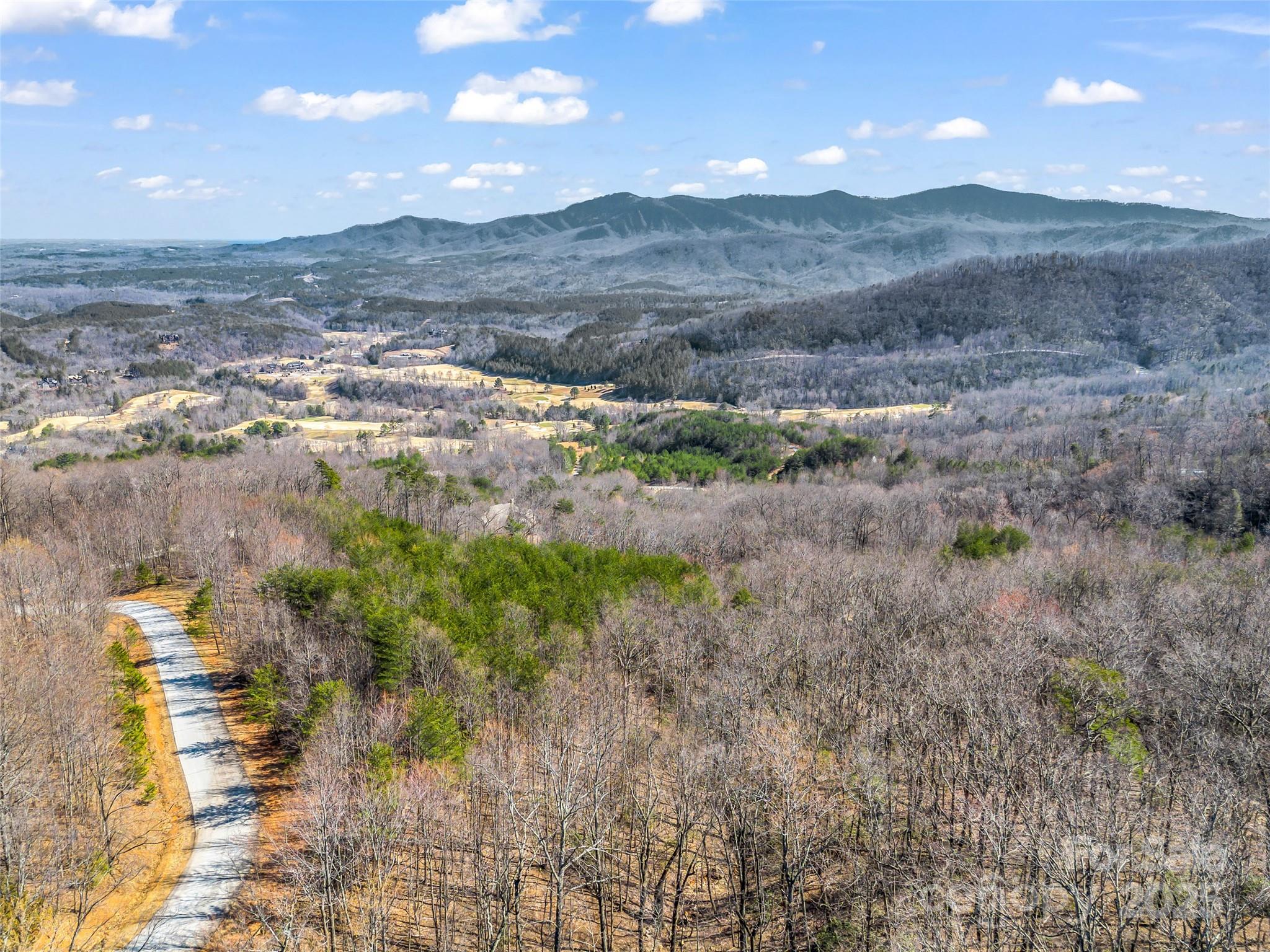 190 Cherry Hill, Unit NONE Mill Spring, NC 28756 - Photo 27 of 32 a view of a lake with mountains in the background