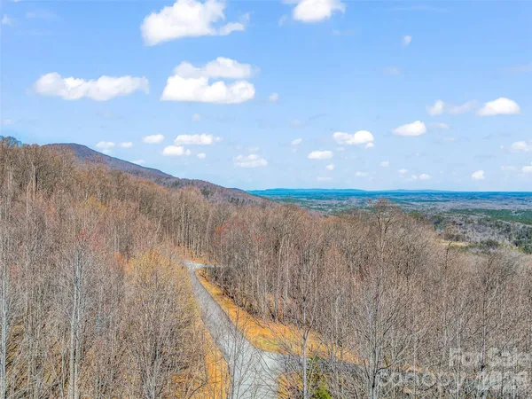 a backyard of a house with yard table and chairs