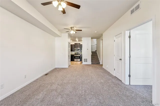 wooden floor in an empty room with a ceiling fan