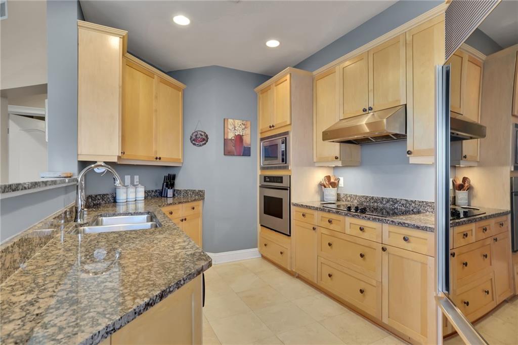 2828 Peachtree Road Northwest, Unit 1901 Atlanta, GA 30305 - Photo 10 of 35 a kitchen with stainless steel appliances granite countertop a stove a sink and a refrigerator