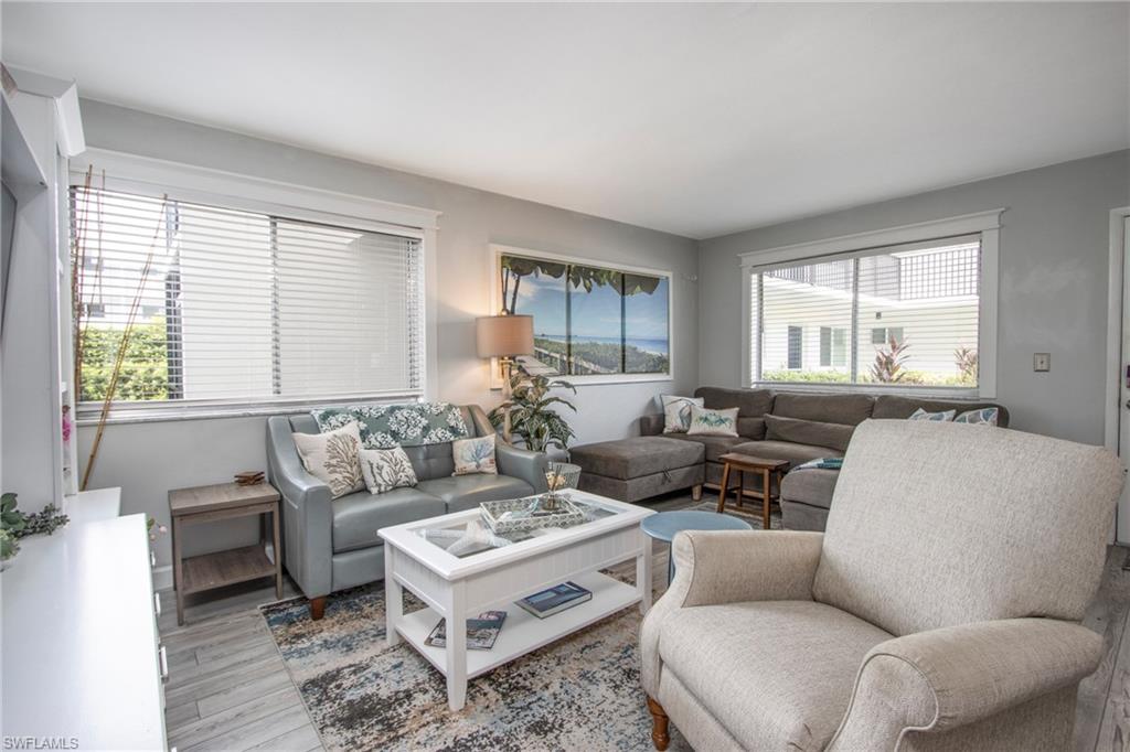 a living room with furniture potted plant and a window