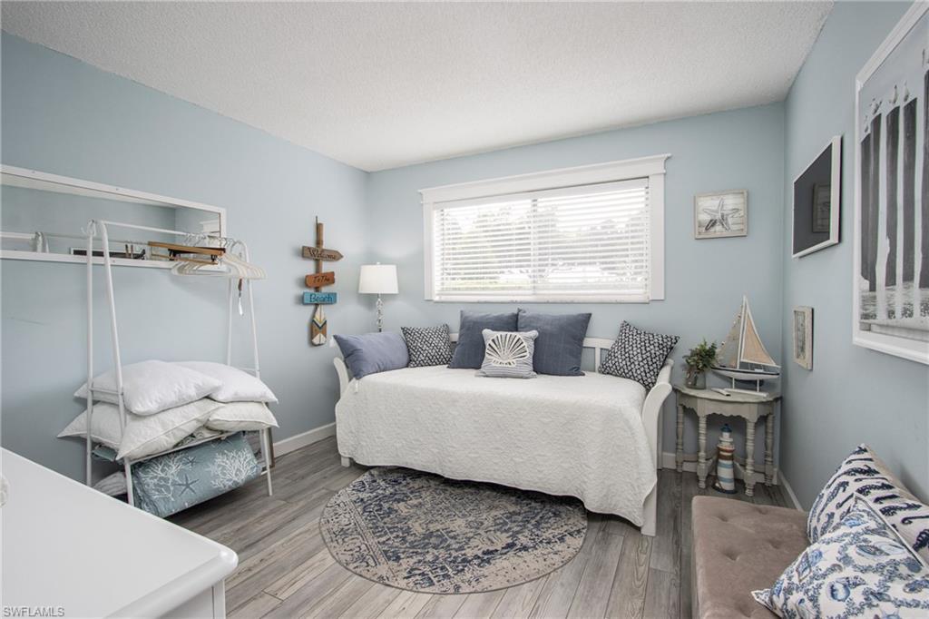 766 Central Avenue, Unit 112 Naples, FL 34102 - Photo 14 of 18 a bedroom with two beds and a window