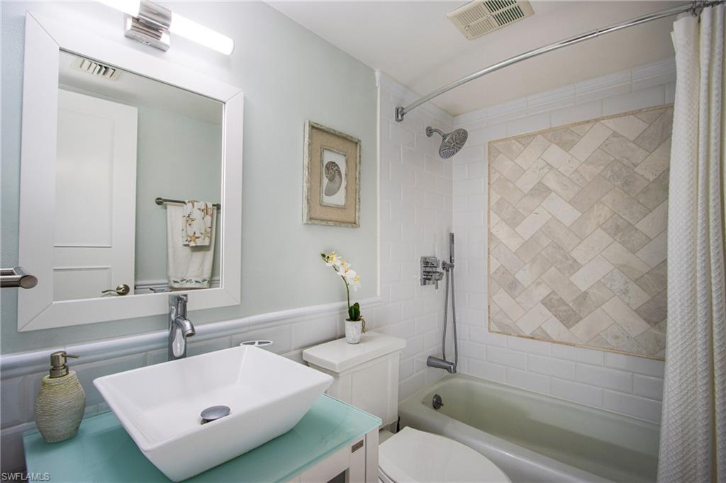 766 Central Avenue, Unit 112 Naples, FL 34102 - Photo 15 of 18 a bathroom with a sink toilet and shower
