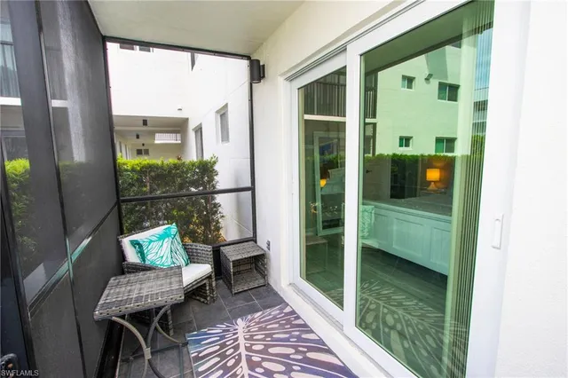 a view of a balcony with chair and table