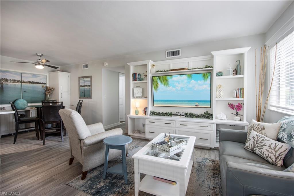 766 Central Avenue, Unit 112 Naples, FL 34102 - Photo 5 of 18 a living room with furniture appliances and a large window