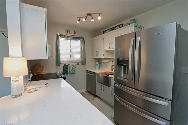 a kitchen with stainless steel appliances a refrigerator sink and stove
