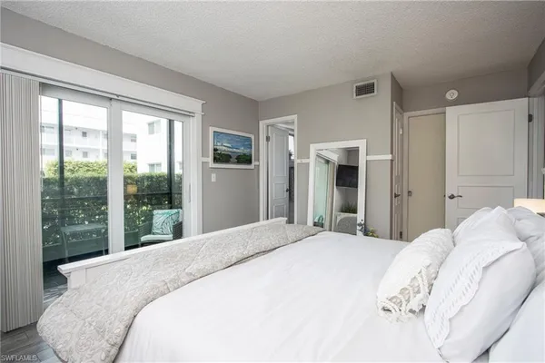 a bedroom with a large bed and a large window