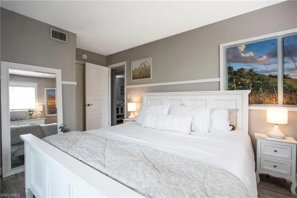 a large white bed in a white room