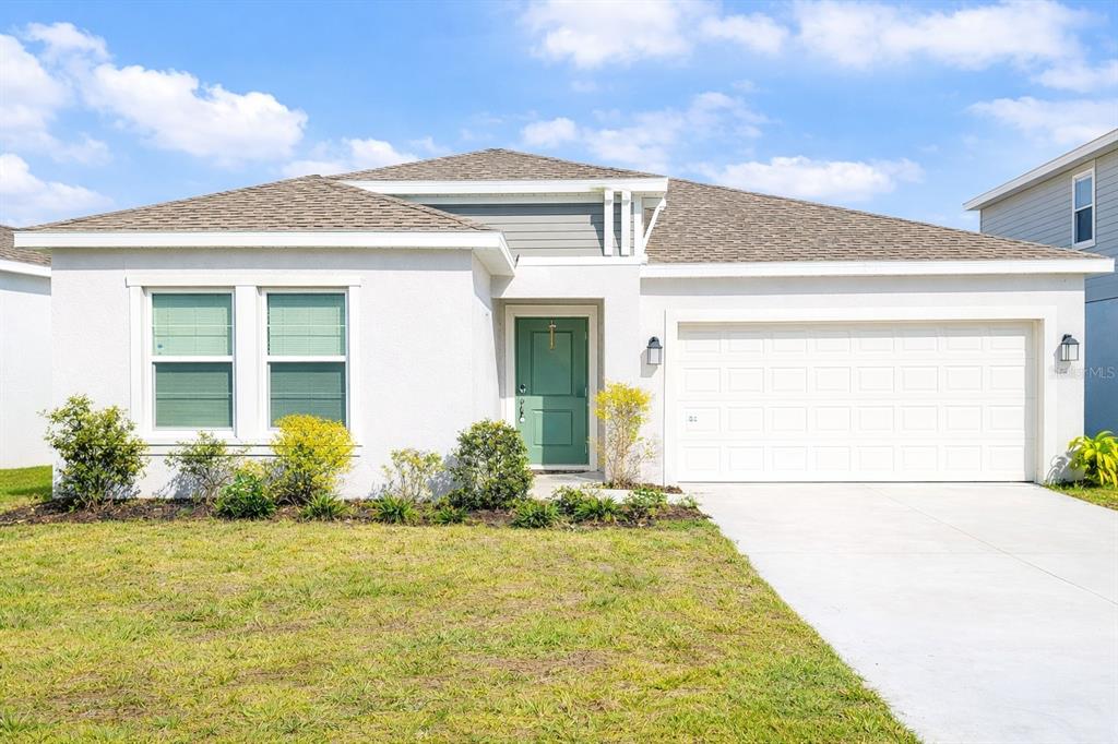 a front view of a house with garden