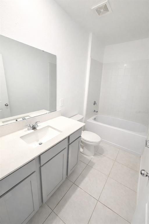 1449 Austin Street Lake Wales, FL 33859 - Photo 12 of 18 a bathroom with a sink a toilet and a large mirror