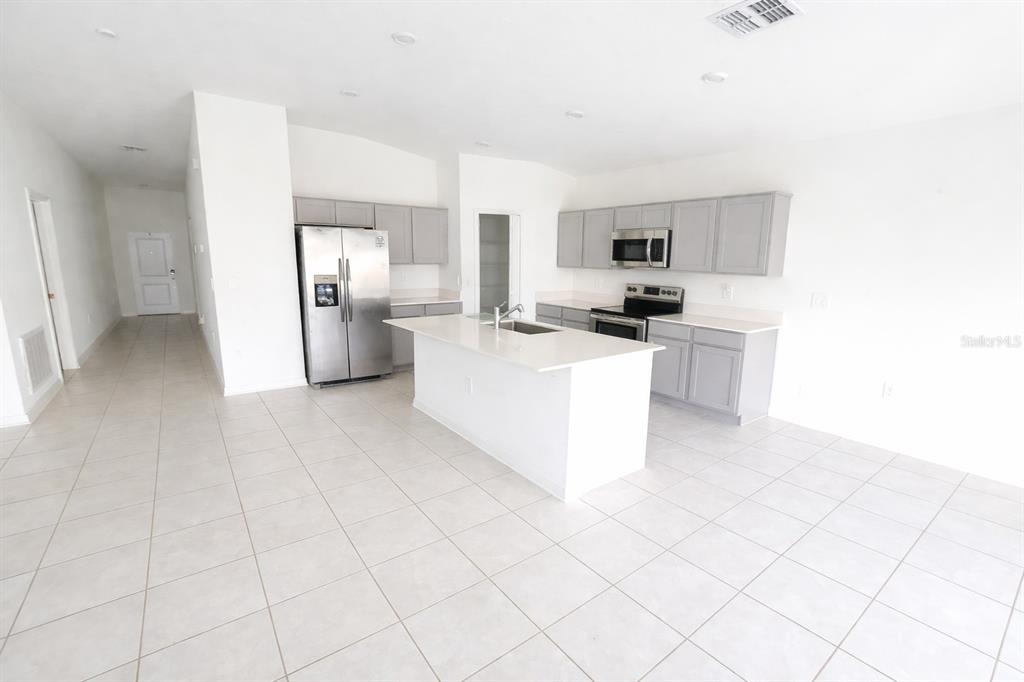 1449 Austin Street Lake Wales, FL 33859 - Photo 2 of 18 a kitchen with stainless steel appliances a refrigerator sink and stove