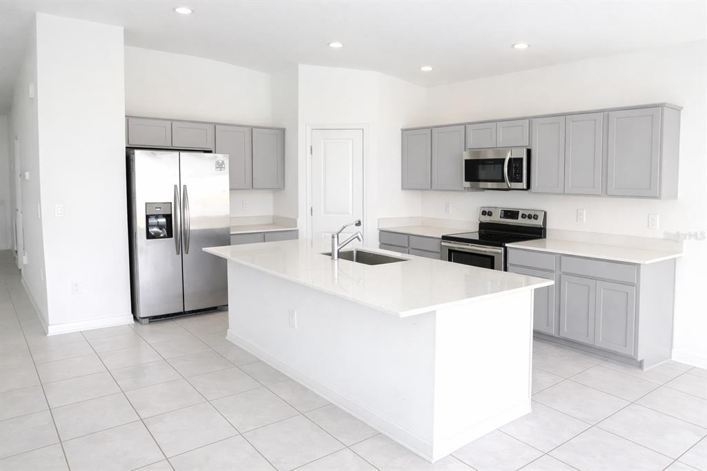 1449 Austin Street Lake Wales, FL 33859 - Photo 3 of 18 a kitchen with stainless steel appliances a refrigerator sink and stove