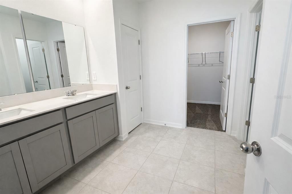 1449 Austin Street Lake Wales, FL 33859 - Photo 9 of 18 a bathroom with a granite countertop sink a mirror and a