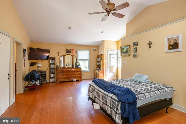 a bedroom with a bed and wooden floor