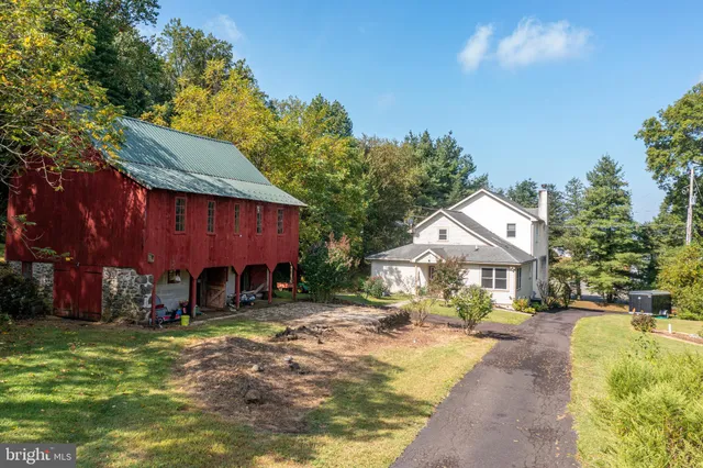 a view of a house with a yard patio and fire pit