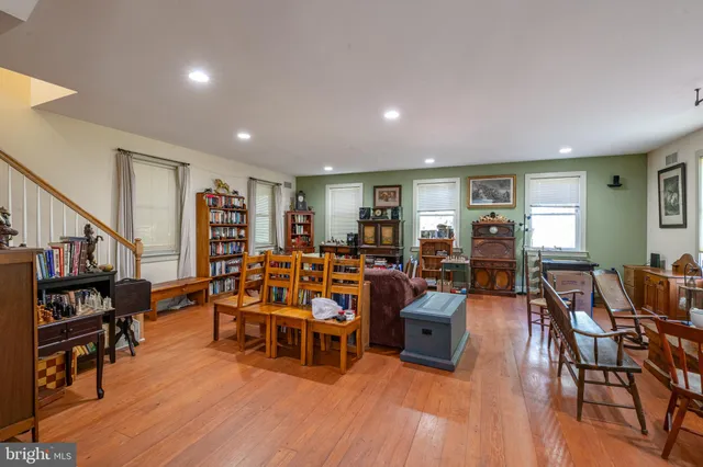 a living room with lots of furniture and wooden floors