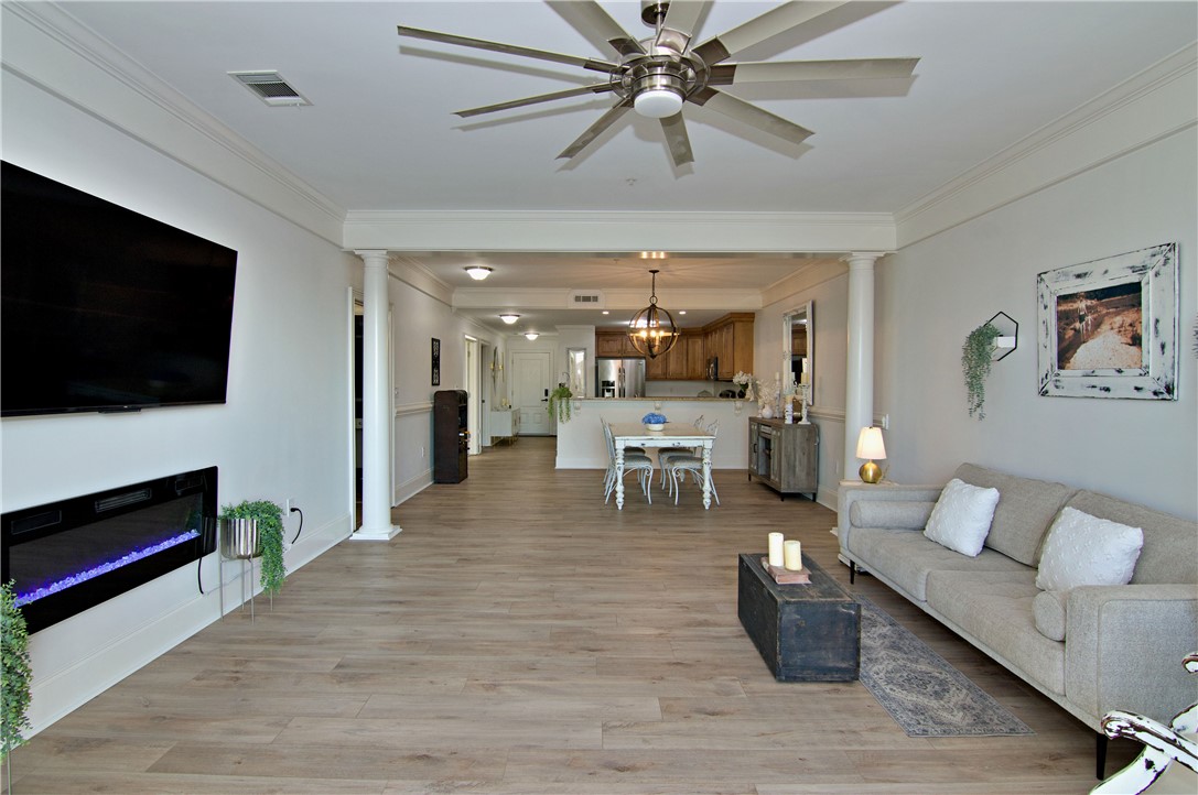 601 Watermarke Lane Anderson, SC 29625 - Photo 7 of 25 This open-concept living area features a modern fireplace and elegant crown molding, perfect for entertaining.