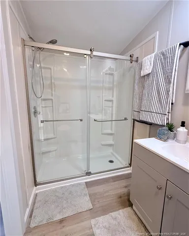 a bathroom with a shower and a sink