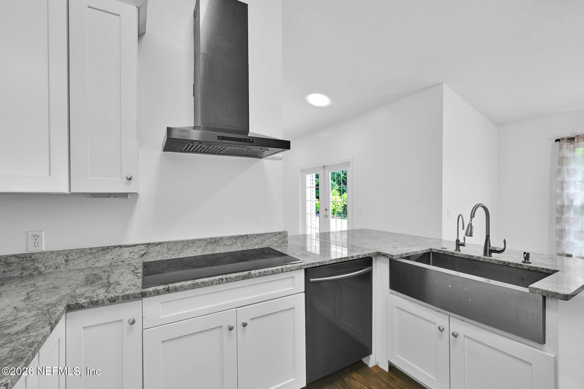 1110 Woodlawn Road, Unit D St. Augustine, FL 32084 - Photo 26 of 40 a kitchen with stainless steel appliances granite countertop a sink and a stove