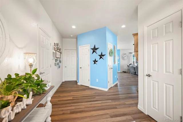 a very nice looking room with wooden floor and a bathroom