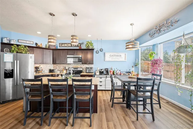 a view of a dining room with furniture window and wooden floor