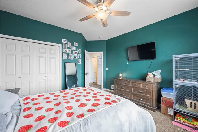 a bedroom with a bed and a flat screen tv in it