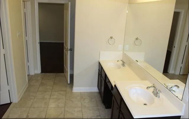 a bathroom with a sink a vanity and a mirror