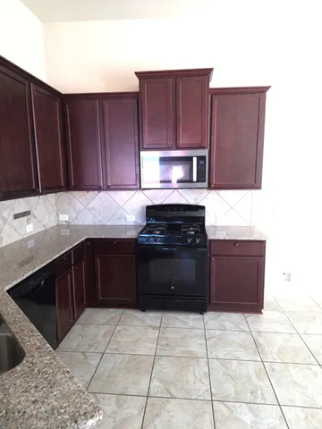 a kitchen with a cabinets and steel appliances