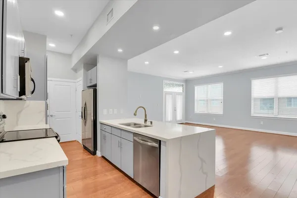 a kitchen with white cabinets and stainless steel appliances