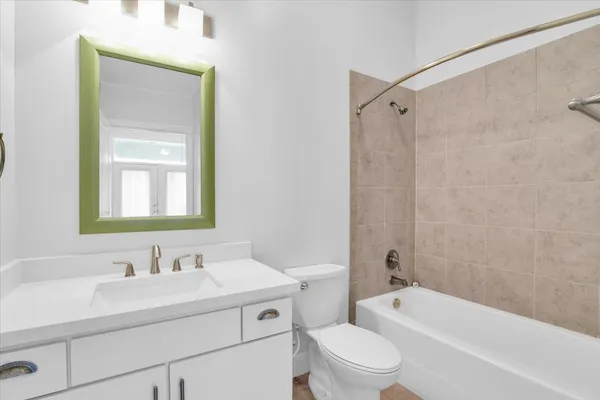 a view of a patio with a table and chairs under an umbrella