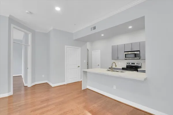 a kitchen with a sink and natural light