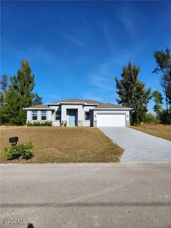 a house with a yard and a wooden fence