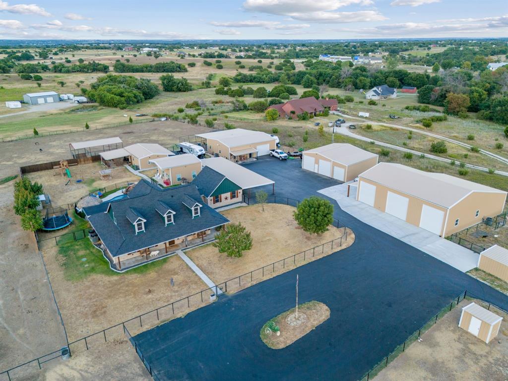 an aerial view of a house with a swimming pool outdoor seating and mountain view
