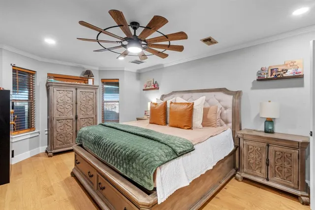 a bedroom with a large bed and a chandelier
