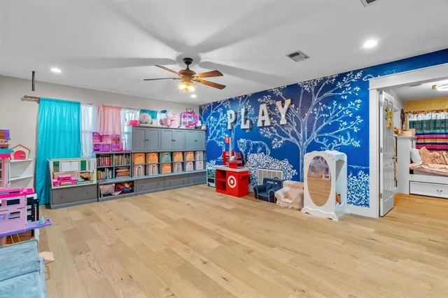 a bed room with a bed mirror and a chandelier