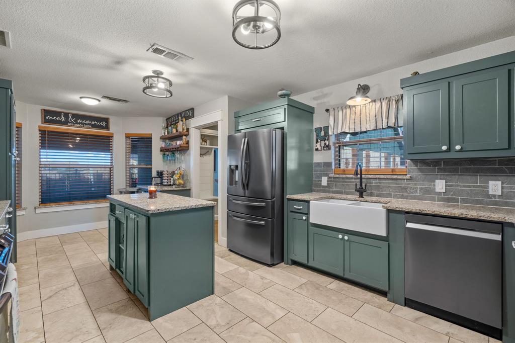 4320 Farm To Market 920 Weatherford, TX 76088 - Photo 5 of 39 a kitchen with a sink and cabinets