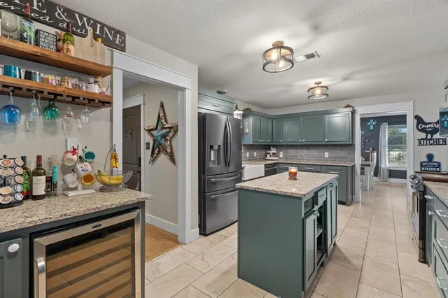 a kitchen with a sink stove and refrigerator