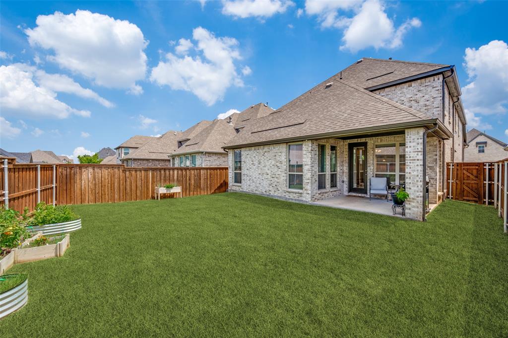 8440 Colburn The Colony, TX 75056 - Photo 25 of 34 Enjoy a spacious backyard with a lush green lawn, offering plenty of room for pets, play, gardening, or future outdoor enhancements. The fully fenced yard provides privacy and a safe space to relax, while the covered patio creates the perfect setting for outdoor entertaining and everyday enjoyment.