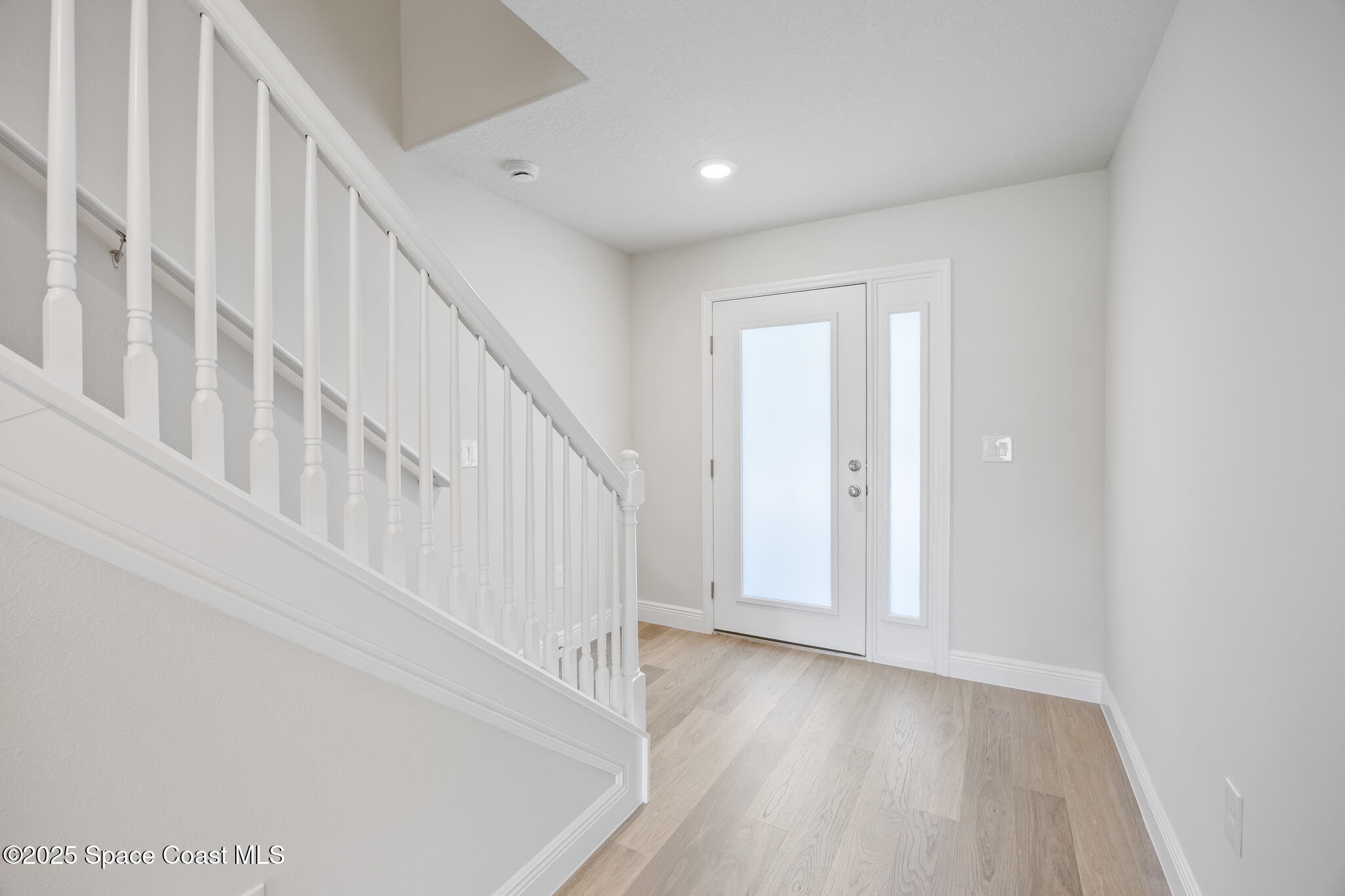 178 Hidden Wds Place Melbourne, FL 32901 - Photo 11 of 24 a view of staircase with white walls and white door