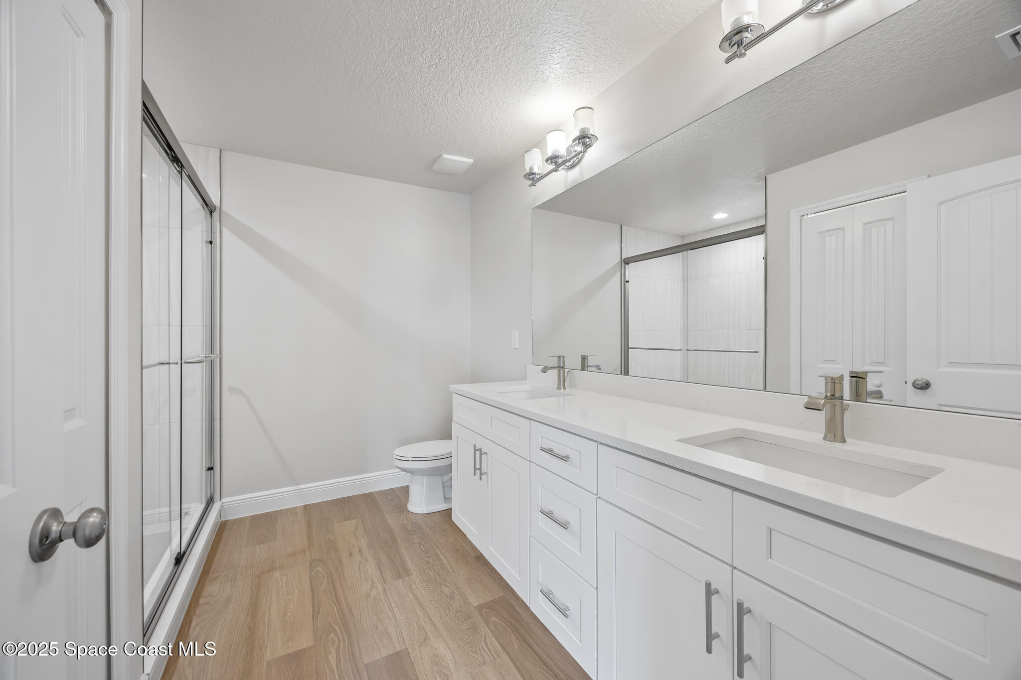 178 Hidden Wds Place Melbourne, FL 32901 - Photo 15 of 24 a spacious bathroom with a double vanity sink a toilet and a mirror