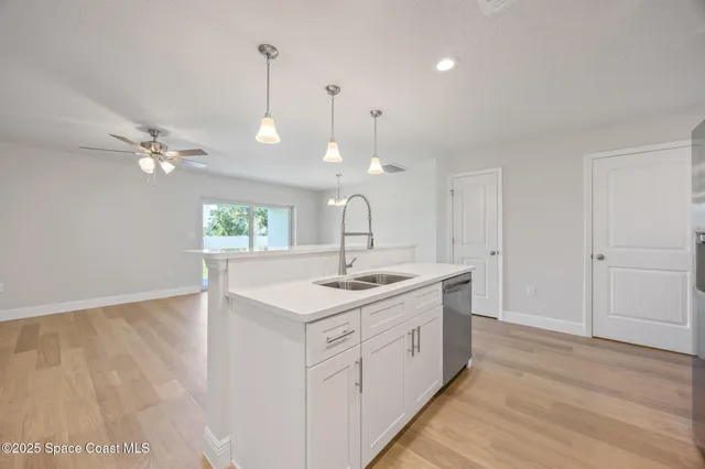 a kitchen with a sink and chandelier