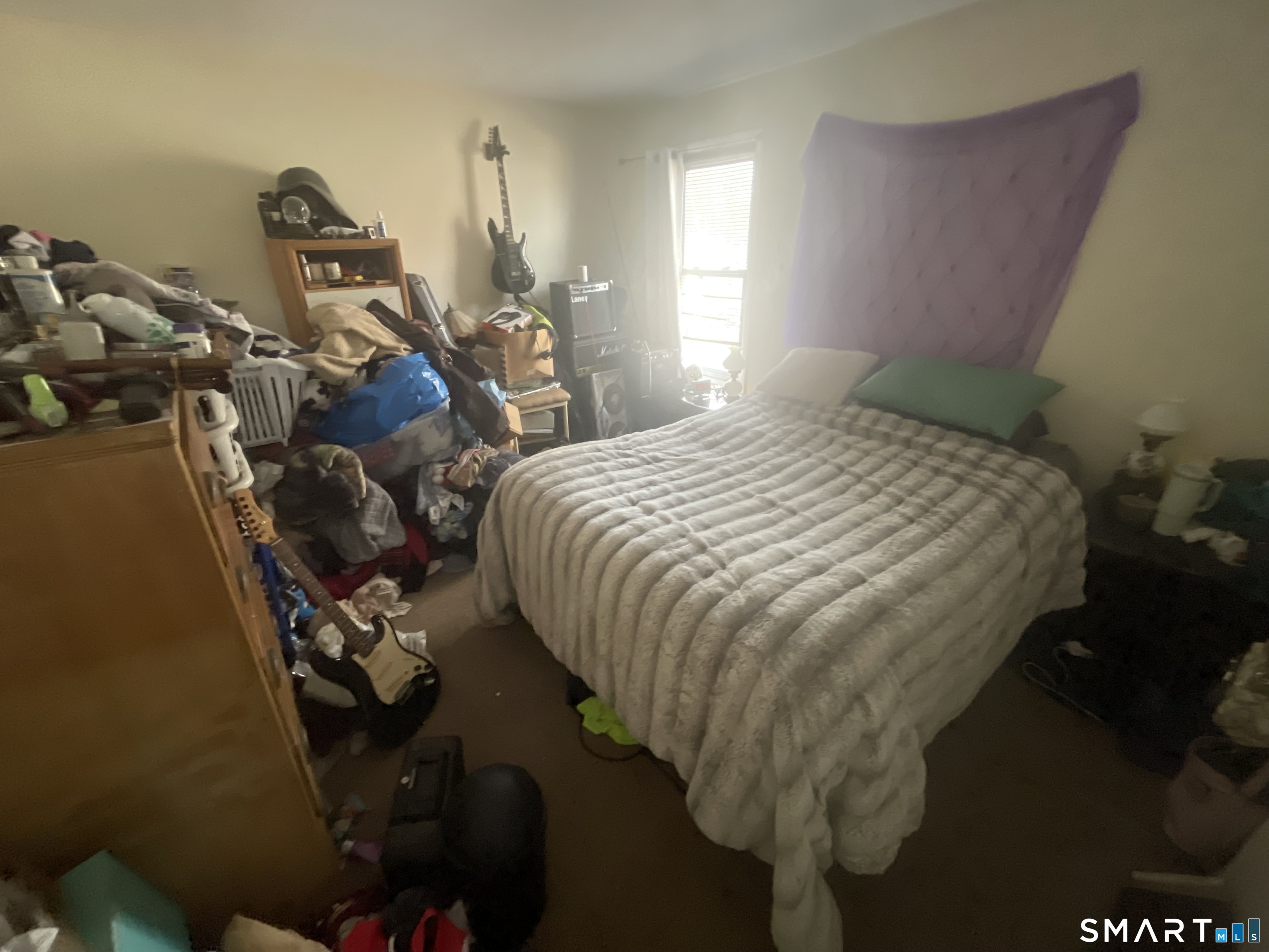 40 Grove Street Ansonia, CT 06401 - Photo 11 of 21 a bedroom with a bed and a chandelier