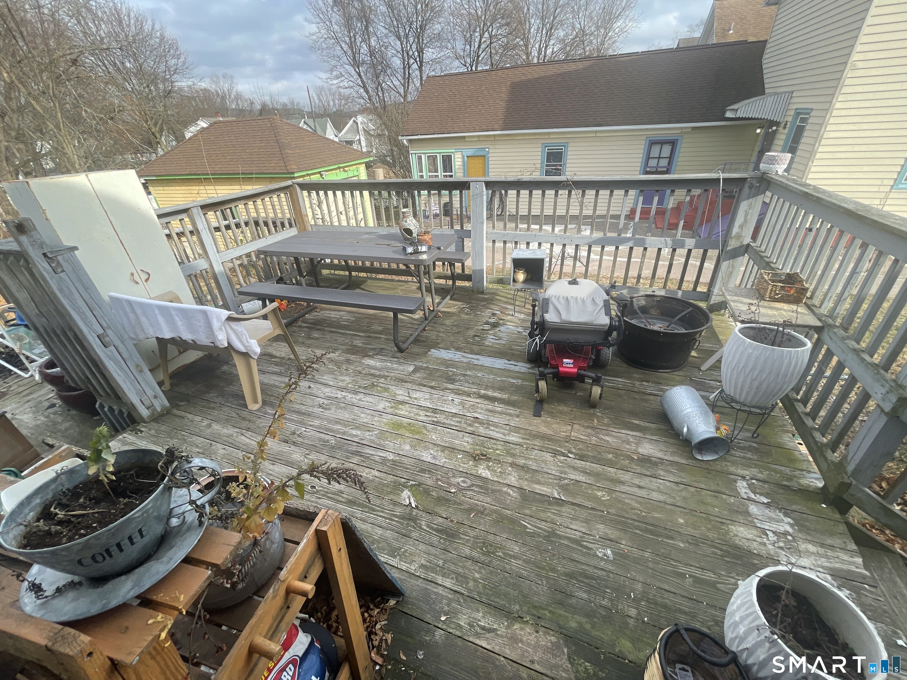 40 Grove Street Ansonia, CT 06401 - Photo 21 of 21 a roof deck with table and chairs and wooden floor