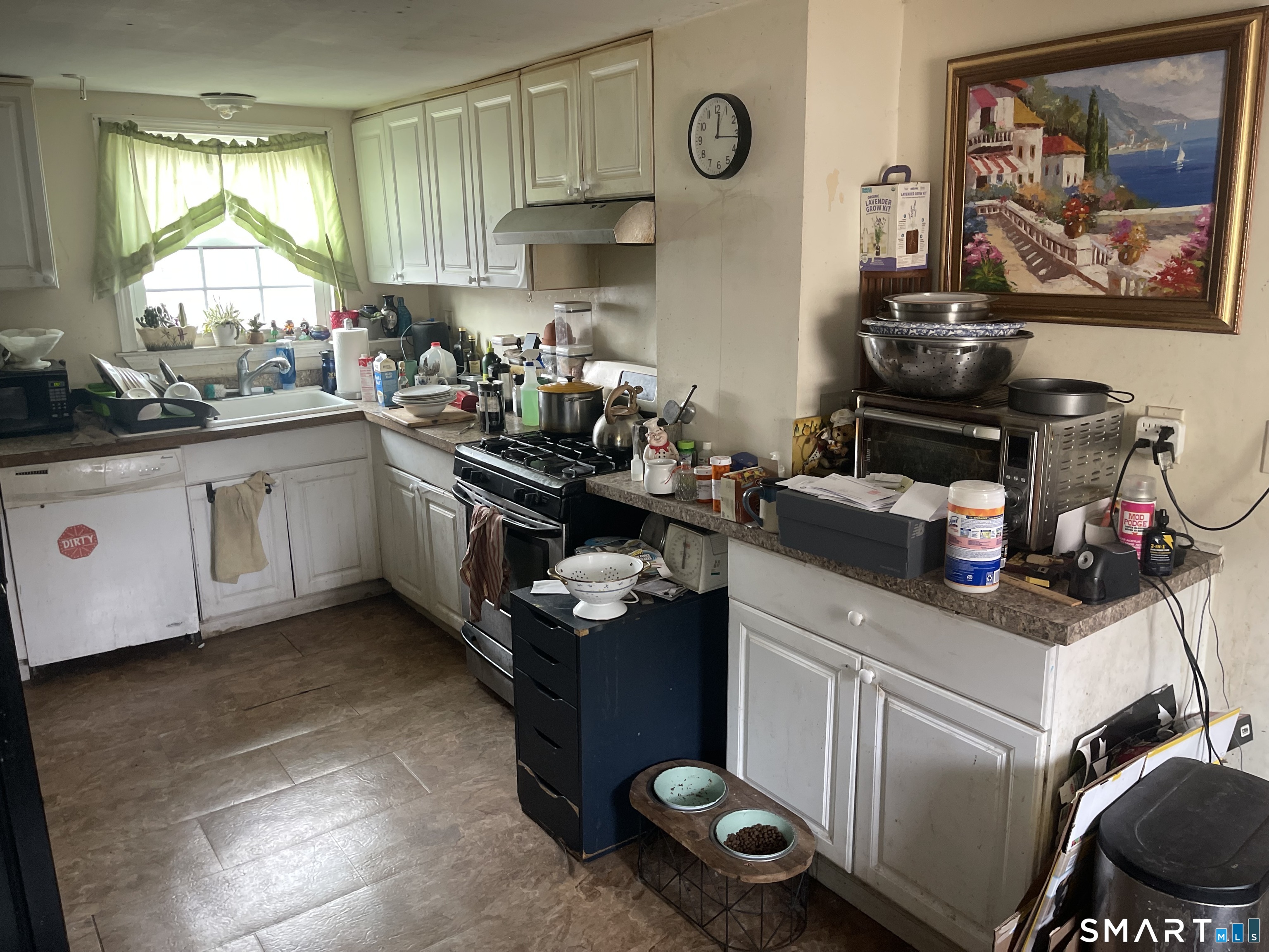 40 Grove Street Ansonia, CT 06401 - Photo 7 of 21 a kitchen with a sink a stove and cabinets